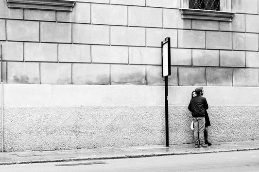 Lovers at bus stop, Palermo, Sicily.  Black and white street photography by Eric Schneider