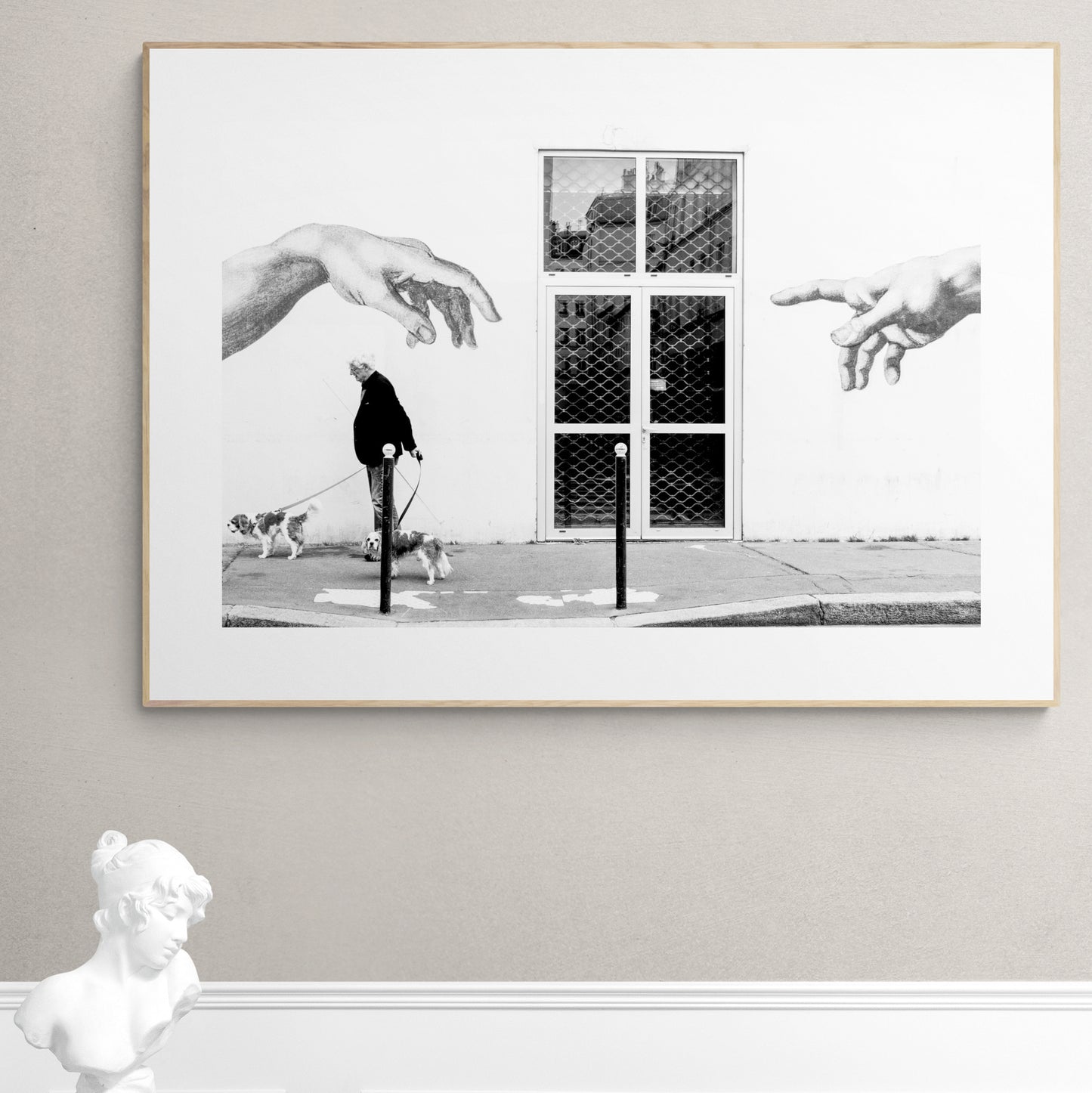 Paris, France. Man, 2 dogs, 2 hands. From Eric Schneider's 'Street' photography series. Black and white photography wall art for homes, offices, hospitals, hotels, restaurants bars and cafes. An extensive collection for collectors, art buyers, interior designers and individuals.