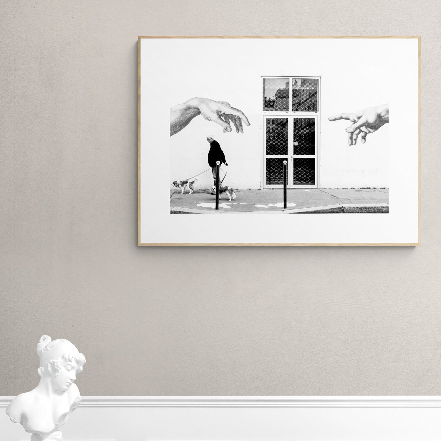 Paris, France. Man, 2 dogs, 2 hands. From Eric Schneider's 'Street' photography series. Black and white photography wall art for homes, offices, hospitals, hotels, restaurants bars and cafes. An extensive collection for collectors, art buyers, interior designers and individuals.