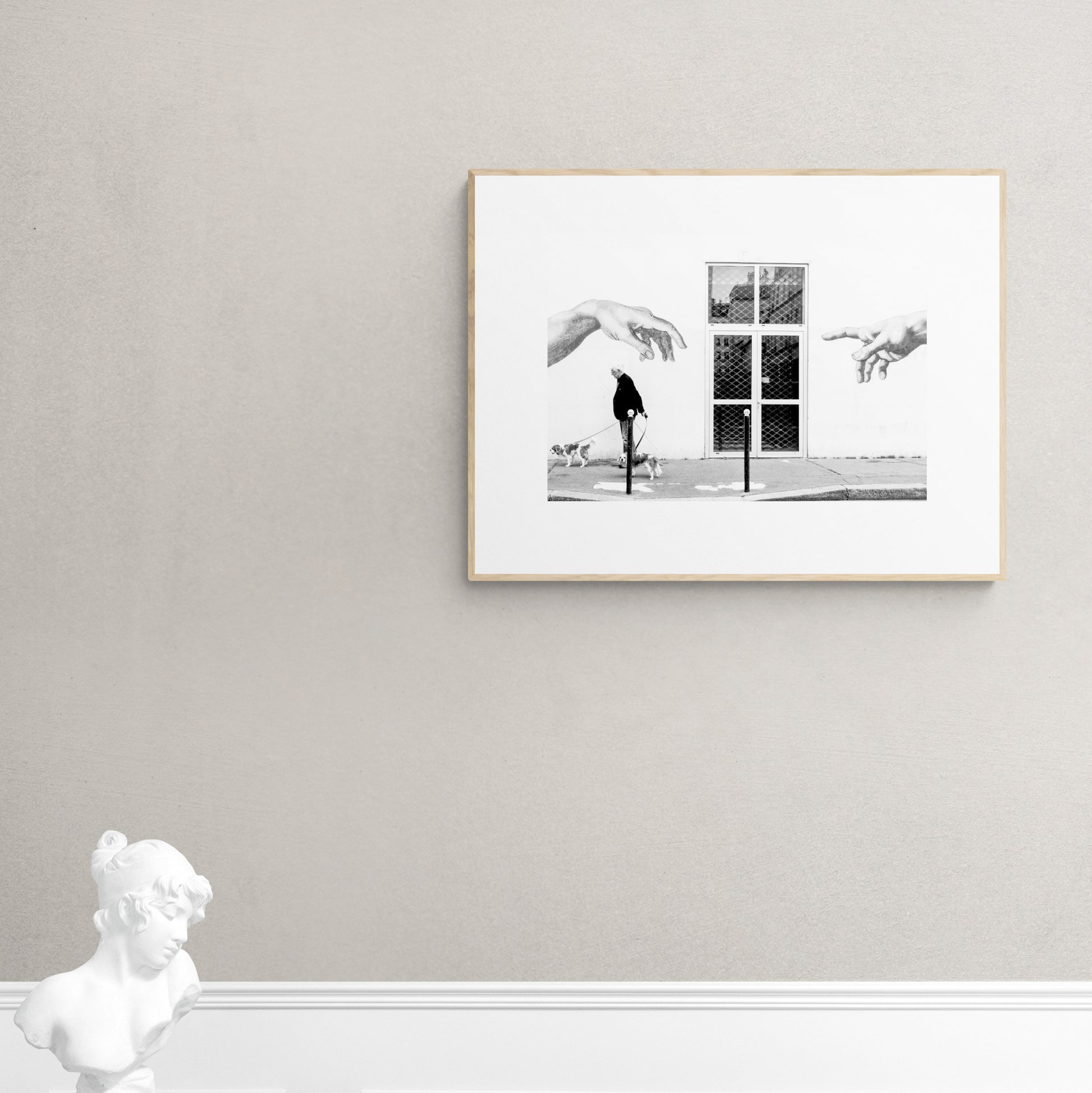 Paris, France. Man, 2 dogs, 2 hands. From Eric Schneider's 'Street' photography series. Black and white photography wall art for homes, offices, hospitals, hotels, restaurants bars and cafes. An extensive collection for collectors, art buyers, interior designers and individuals.