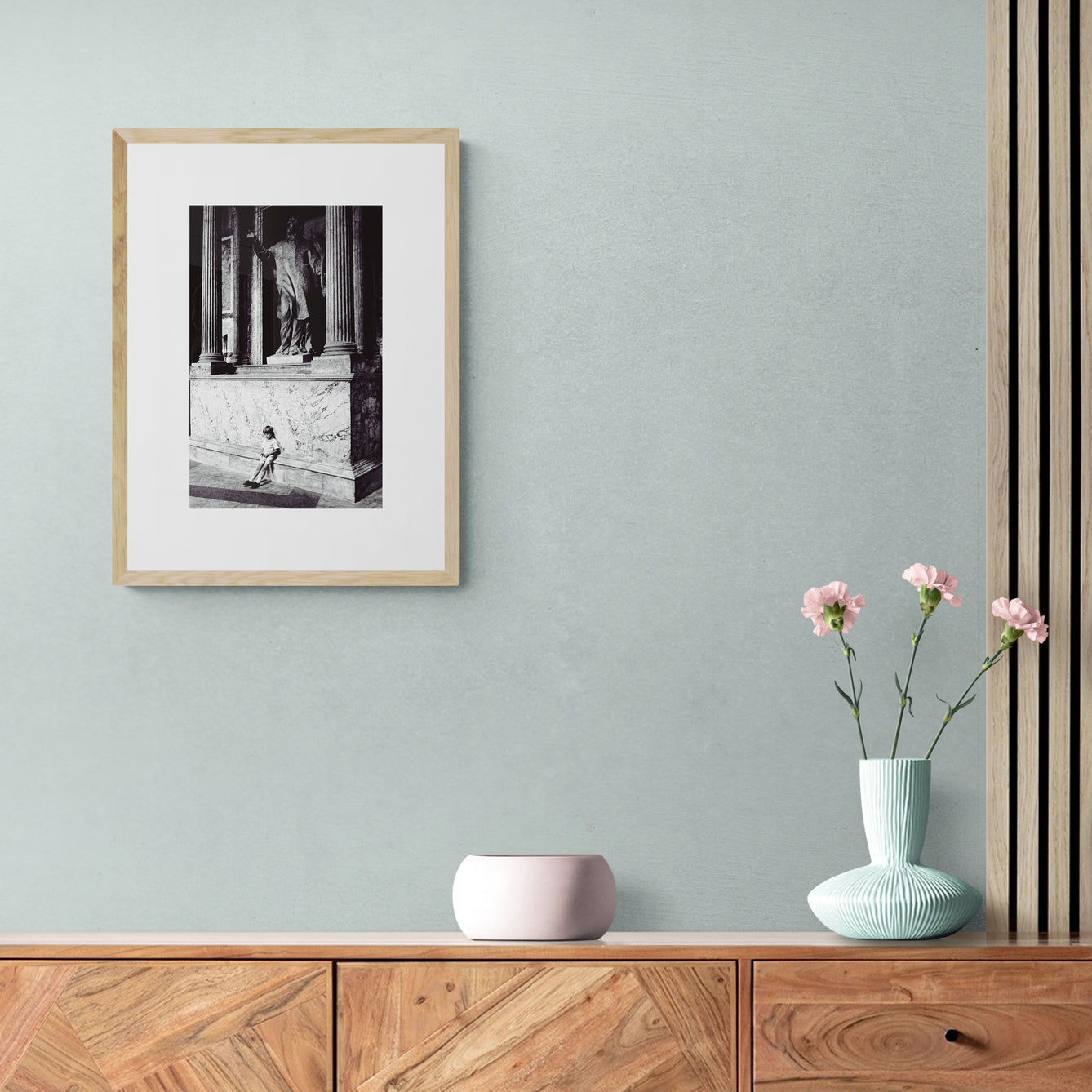 Vintage street black and white film photography, boy leaning against statue in the Pantheon Rome. c1970