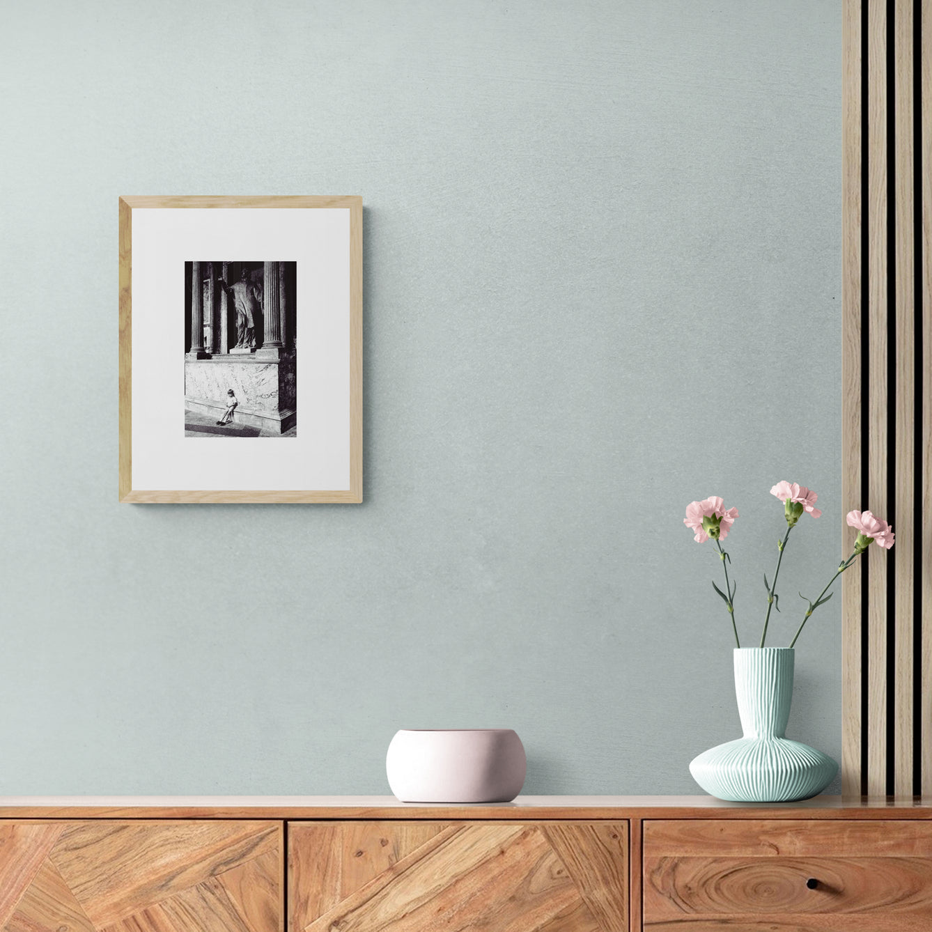 Vintage street black and white film photography, boy leaning against statue in the Pantheon Rome. c1970