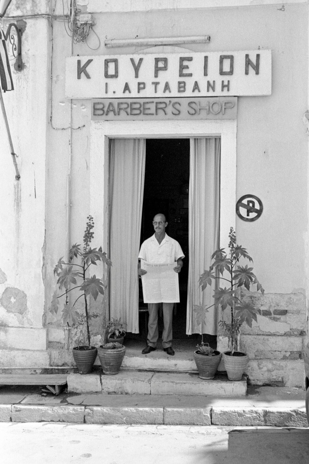 Vintage street black and white film photography, boy leaning against statue in the Pantheon, Rome. c1970