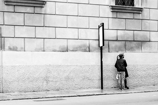 Lovers at bus stop, Palermo, Sicily.  Black and white street photography by Eric Schneider