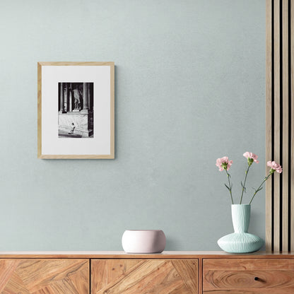 Vintage street black and white film photography, boy leaning against statue in the Pantheon Rome. c1970